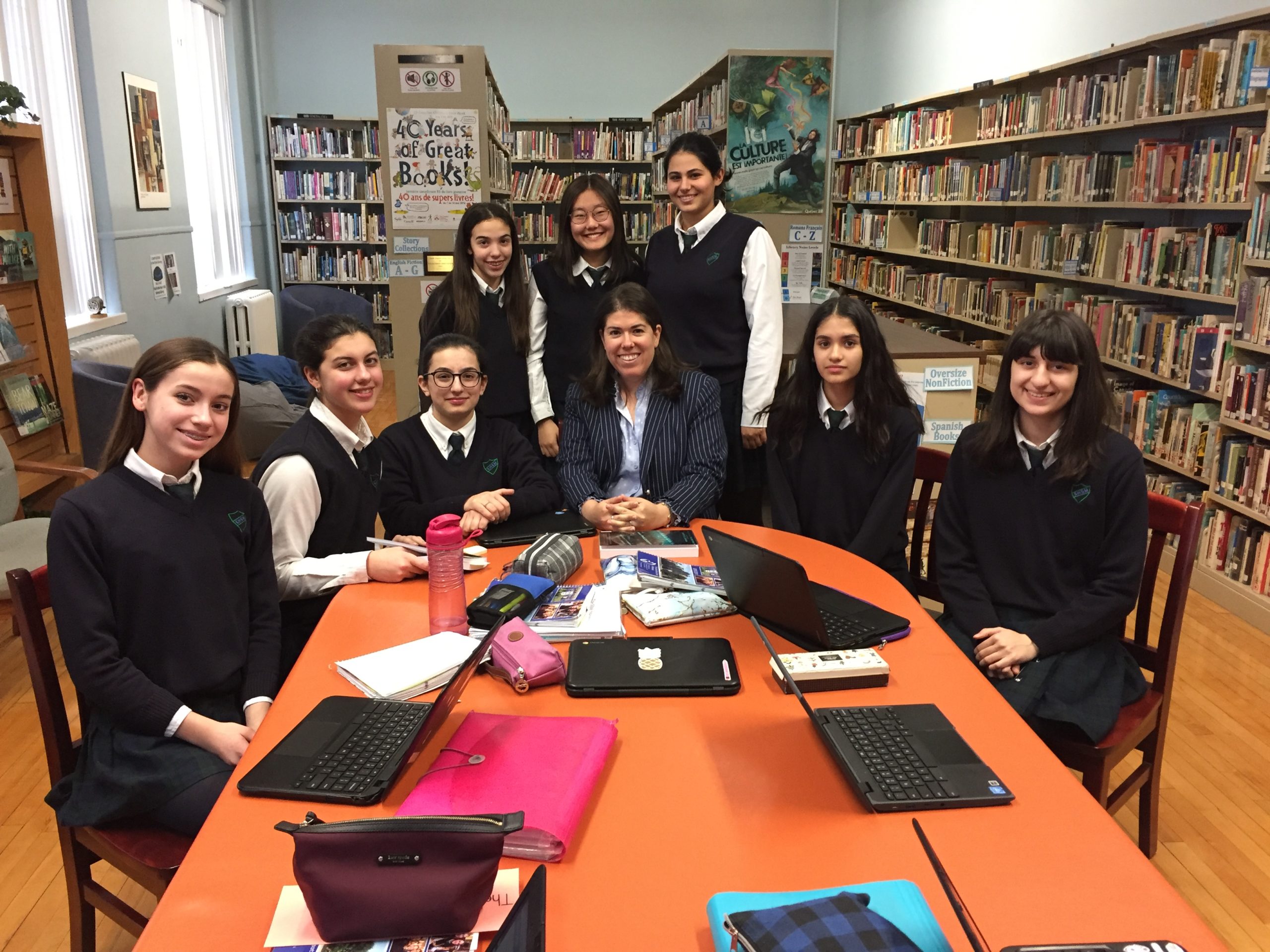 Prime Minister's Award for Teaching Excellence recipient Erika Rath with students at The Sacred Heart School of Montreal library